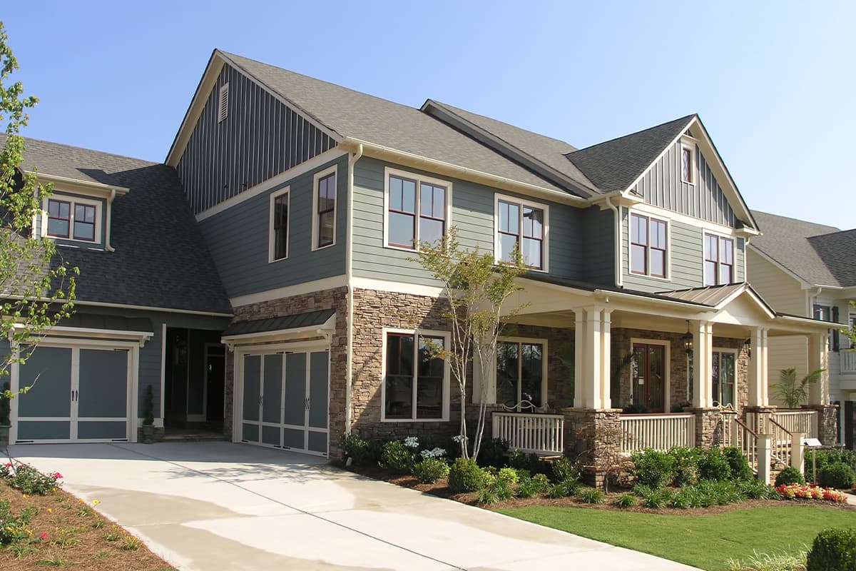 Home with green siding and stone veneer
